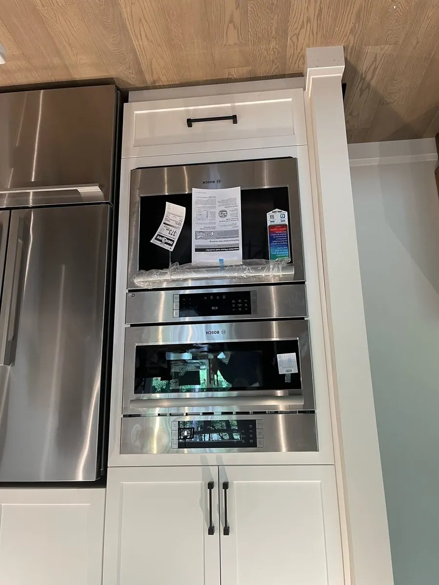 Double wall ovens and a built-in microwave installed in a cabinet column