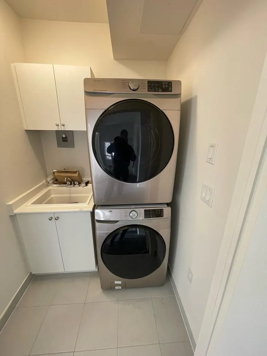 Stacked washer and dryer installed in a laundry closet